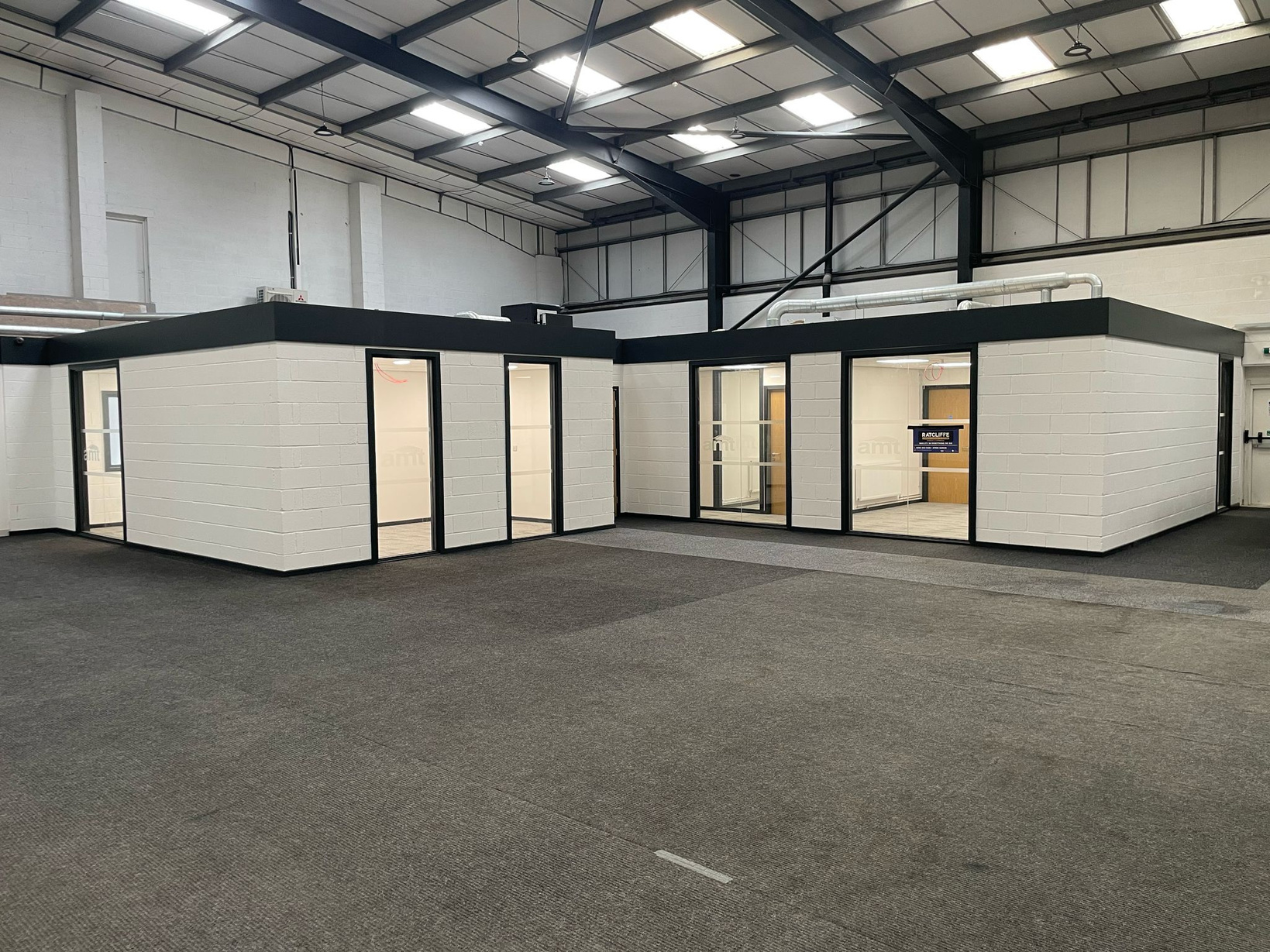 AMT Auto Showroom — office pods in industrial warehouse, Leeds